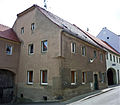 Residential house with side extension, in half-open development