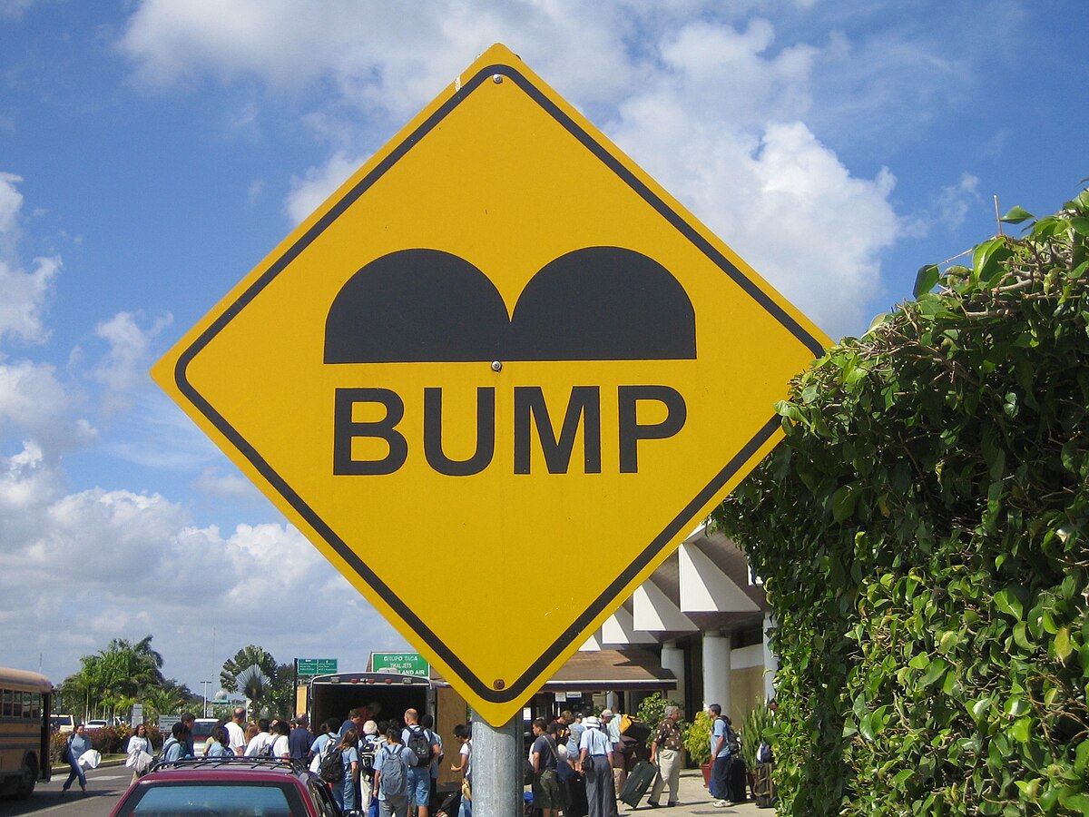 1200px-Belize_Speed_Bump_Sign.JPG