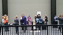 The Turbine Hall, Tate Modern, London. As part of the 2016 Week of Action, DPAC activists set up an unscheduled "pop up gallery" of artworks by disabled people. The art highlighted the experiences of disabled people dealing with the welfare system. DPAC guerilla pop up art at Tate Modern Sep2016.jpg