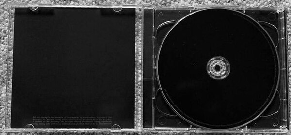 The opened CD jewel case of Donda which, including the disc itself, is entirely plain black