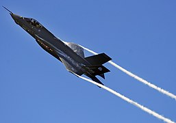 An F-35 Lightning II Joint Strike Fighter test aircraft banks over the flightline at Eglin Air Force Base, Fla., April 23, sending contrails streaming off the wings. The aircraft is the first F-35 to visit the base which will be the future home of the JSF training facility.