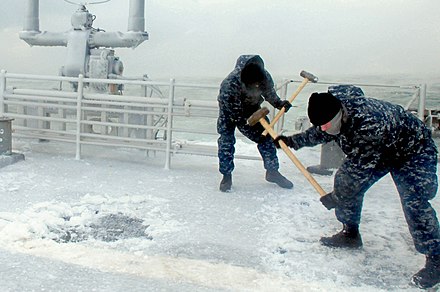 American sailors clearing ice from ship topsides