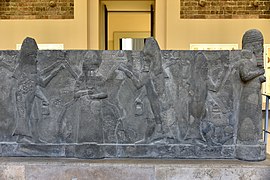 God Ea (Sumerian Enki) with a fish-cloaked apkallus, part of a basalt water basin from Assur, Iraq, reign of Sennacherib, 7th century BCE. Pergamon Museum.jpg