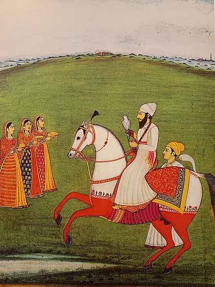 Guru Arjan hunting while mounted on horseback with a hawk. Painting from Faizabad, circa 1760.