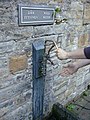 Hand-pump by the bathing pool, providing drinkable water from the source