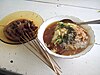 ''Mie ongklok'' (right) served with beef satay (left)