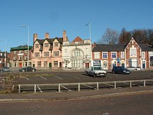 A row of buildings in Middleton's town centre, including one (second from the left) by local born architect Edgar Wood. Several buildings in the town are known to be by Wood.