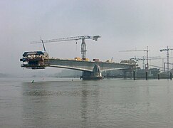 This concrete bridge temporarily functions as a set of two balanced cantilevers during construction - with further cantilevers jutting out to support formwork.