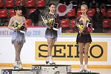 The women's podium at the 2018 Internationaux de France. From left: Mai Mihara (2nd), Rika Kihira (1st), Bradie Tennell (3rd) Podium-IMG 3316.jpg