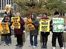 Demonstrators in Minneapolis hold placards on March 21, 2011, to protest Operation Odyssey Dawn. Protest against US military action in Libya 1.jpg