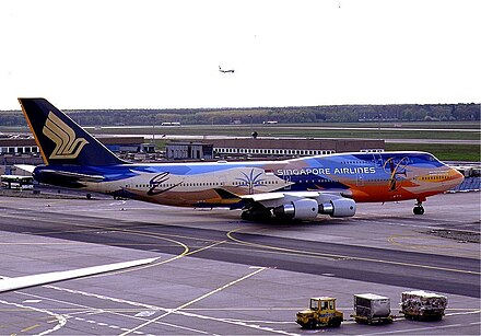 A Singapore Airlines Boeing 747-400 (registered as 9V-SPK) in the Tropical livery. This aircraft was involved in the Singapore Airlines Flight 006 accident.