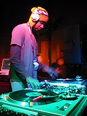 A DJ mixing vinyl records with a DJ mixer at the Sundance Film Festival in 2003 Spooky.jpg