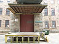 Beneath the interface of Stone Mill and the skeleton of an industrial bridge connecting the building with Everett Mills. Located near 15 Union Street, Lawrence, Massachusetts.