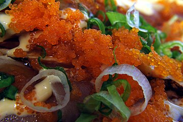 Tobiko, shown in its natural color, topping grilled albacore tuna