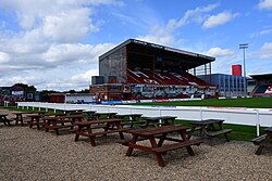 Picnic tables and the Roger Millward West Stand from the 'Craven Streat' complex at Sewell Group Craven Park.