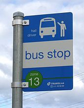 A 'flag pole' sign used at regular bus stops. The sign contains zone information and TransLink's phone number. TransLink Flag Pole Bus Stop Sign.jpg