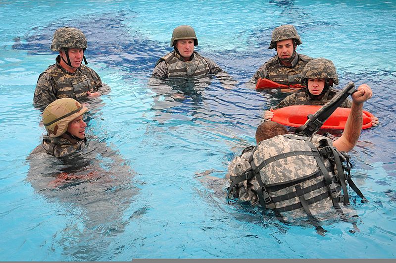 File:U.S. Air Force Tech. Sgt. Adam May, foreground, demonstrates how to remove your pack after you have entered the water during the Marine Combat Water Survival Training at a swimming pool at an undisclosed 110425-F-KE165-476.jpg