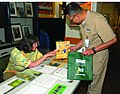 Miniatuur voor Bestand:US Navy 100421-N-9330D-004 Karen Pyles, left, offers Chief Warrant Officer 4 Noe Tuparan recycling tips at an information fair at National Naval Medical Center Bethesda.jpg