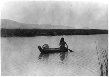 A Pomo Indian in a small tule boat in 1924 Upper lake Pomo In the tule swamp.jpg