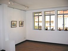 A view of Martin Loh's artwork in a corner of Utterly Art, next to the windows.