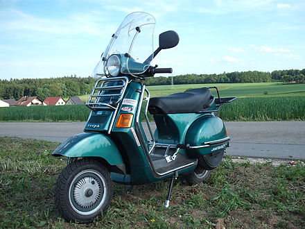 A second generation Vespa Cosa with aftermarket luggage rack and crash bars.