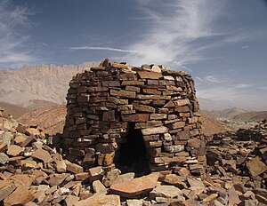 מבנה קבורה באל-עין, עומאן. המבנה הוא מגדל אבנים מעגלי, עם פתח משולש במרכזו.