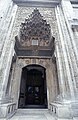 The entrance to the mosque, featuring a carved muqarnas portal.