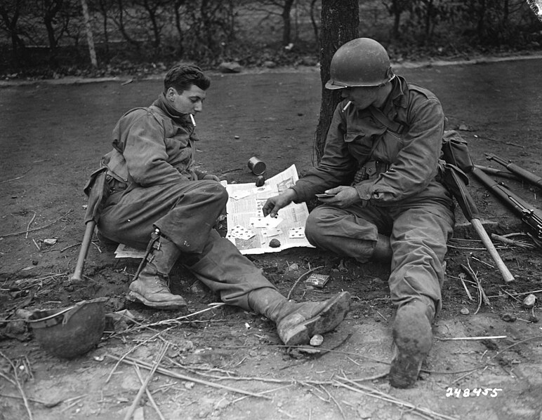 File:111-SC-248455 - PFC George Cap, from Prior Lake, Minn., and Pvt. James McFarland, of Zanesville, Ohio, both of the 1st Division, U.S. First Army, play cards, as they wait for orders to move out of Vettweiß, Germany (cropped).jpg