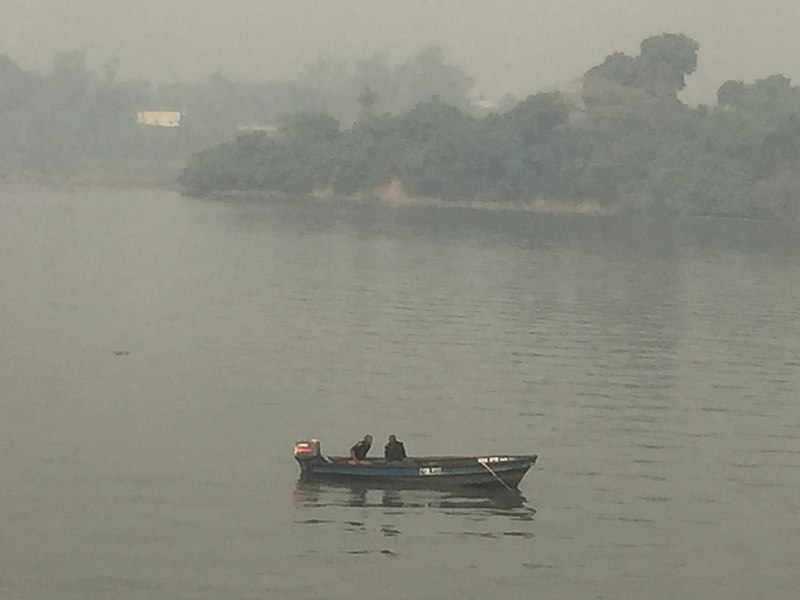 File:A canoe conveying passenger beneath Third mainland Bridge, Lagos.jpg