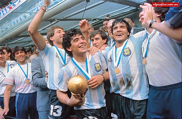 Diego Maradona (with the World Cup) and teammates celebrating the title