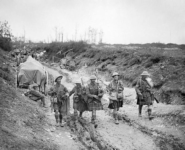 A piper of the 7th (Service) Battalion, Seaforth Highlanders leads four men of the 26th Brigade back from the trenches after the attack on Longueval, 