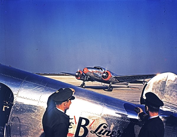 Braniff pilots outside a "B-Liner" Lockheed Model 10 Electra, Houston Municipal Airport, 1940. In the background is a Lockheed Model 12 Electra Junior