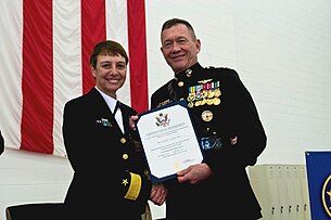 Jaynes receiving her retirement certificate from Marine Corps Lt. Gen. Jon Davis. Cindy Jaynes and Jon Davis.jpg