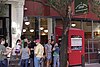 Line of people waiting outside red restaurant with sign saying Clinton St. Baking Company & Restaurant