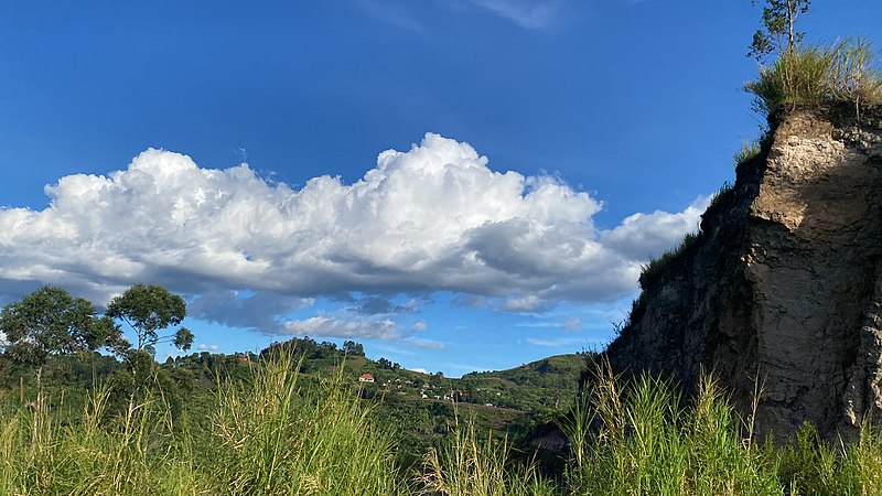 File:Clouds over a hilly landscape with a rocky hill in Rubirizi District in Western Uganda.jpg