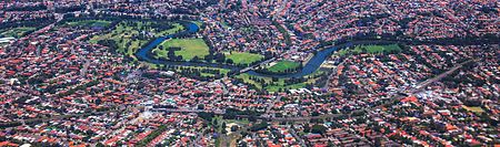The line roughly parallels the Cooks River between Sydenham and Campsie Cooks River and Bankstown railway line from the air (13113706185).jpg