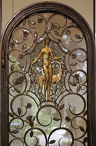 Art Deco volutes on a pair of elevator doors, by Edgar Brandt, 1926, wrought iron, glass, and patinated and gilded bronze, Calouste Gulbenkian Museum, Lisbon[13]