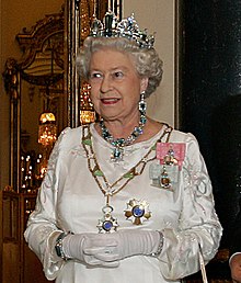 Queen Elizabeth II wearing the royal family orders of King George V (her grandfather) and King George VI (her father) in 2006. The star and collar are a Brazilian decoration, the Order of the Southern Cross. Elizabeth II, Buckingham Palace, 07 Mar 2006 crop.jpeg