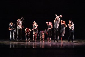 Members of an American jazz dance company perform a formal group routine in a concert dance setting GDC onlywayaround.jpg