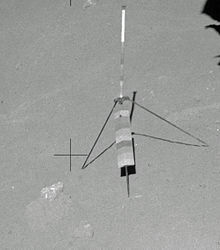 The Genesis Rock on the lunar surface prior to sampling (left of the gnomon, which was used for scale in the photos) Genesis rock in situ AS15-90-12227.jpg