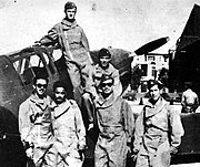 Group of soldiers next to a plane