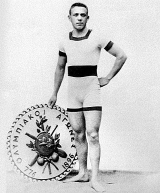 A man in swimming attire holding an emblem inscribed with "Olympic Games" in Greek lettering and the numbers 776 and 1896