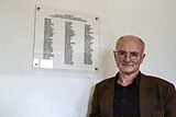 Hans Joachim Lang in front of the plaque in memory of 86 Jews killed in August 1943 in the gas chamber of Natzweiler-Struthof concentration camp.