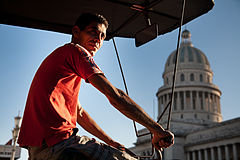 Street life: A "Bicitaxi" driver in front of the Capitolio. Havana (La Habana), Cuba