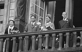 King Bhumibol Adulyadej and Queen Sirikit appearing on the balcony of Royal Palace of Amsterdam; from left to right: Queen Juliana of the Netherlands, King Bhumibol Adulyadej, Queen Sirikit and Prince Bernhard of Lippe-Biesterfeld, 25 October 1960 Koningspaar van Thailand bezoekt Rotterdam, het koninklij gezelschap op het balk, Bestanddeelnr 911-7012.jpg