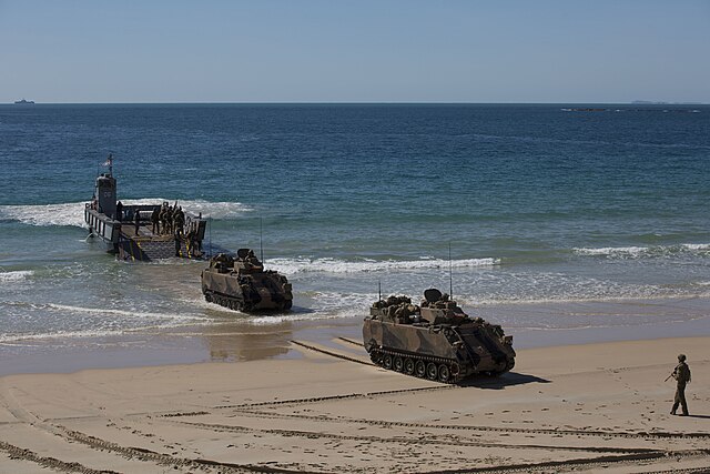 Two Australian M113s disembarking from a landing craft during a training exercise in 2019