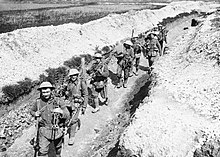 Tommies of the King's (Liverpool) Regiment carrying barbed wire picket posts along a communication trench near Blairville Wood, 16 April 1916. Men of the King's Liverpool Regiment carrying barbed wire picket posts along a communication trench near Blairville Wood, 16th April 1916. Q525.jpg