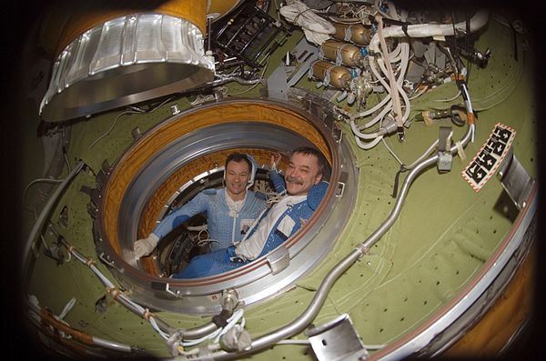 Commander Michael E. López-Alegría (left) and cosmonaut Mikhail Tyurin conduct pre-spacewalk operations in the Pirs airlock (February 2007)