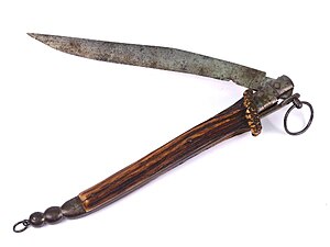 Navaja dating to c. 1790; it has a yataghan style blade, a stag-horn handle and the pull-ring for disengaging the blade-locking mechanism is clearly visible Navaja Folding Knife, Circa 1790.jpg