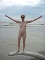 Nudist woman standing on log.jpg